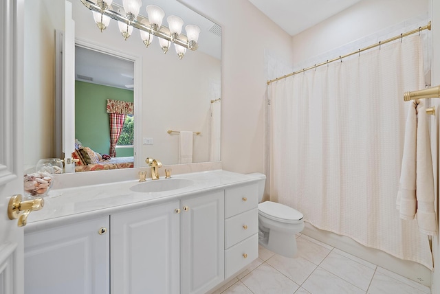 bathroom with toilet, ensuite bathroom, tile patterned floors, shower / bath combo with shower curtain, and vanity