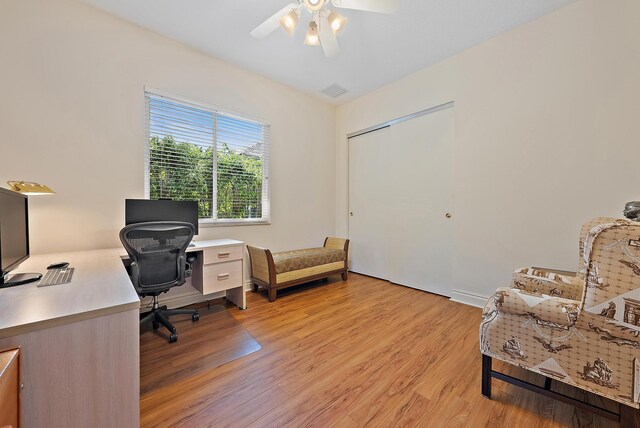 home office with ceiling fan and light wood-style floors