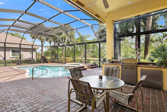 view of pool with a patio area, a pool with connected hot tub, an outdoor kitchen, and area for grilling