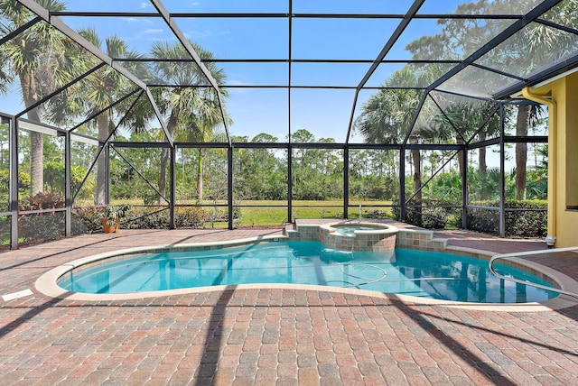 view of pool featuring a pool with connected hot tub, a patio area, and a lanai