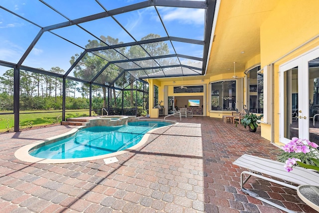 view of swimming pool featuring glass enclosure, a pool with connected hot tub, french doors, and a patio