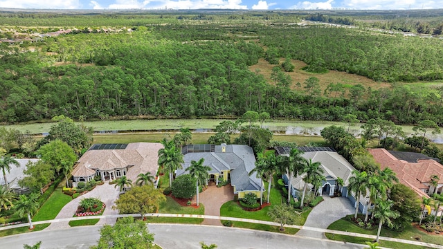 birds eye view of property with a residential view and a view of trees