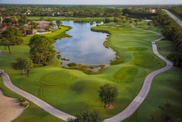 birds eye view of property with a water view and view of golf course