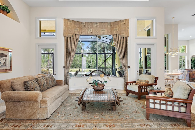 living area with a towering ceiling and a notable chandelier