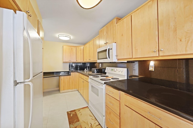 kitchen with white appliances, dark countertops, light brown cabinetry, backsplash, and light tile patterned flooring