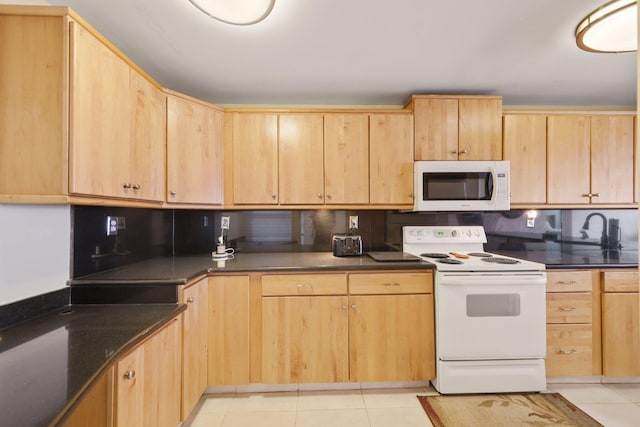 kitchen with white appliances, light tile patterned floors, and light brown cabinetry