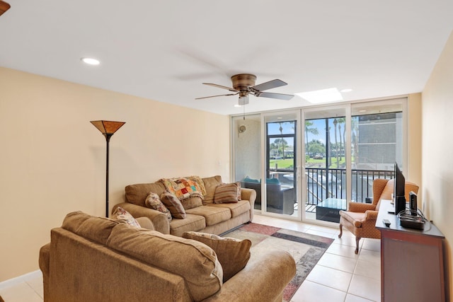 living area with recessed lighting, floor to ceiling windows, light tile patterned flooring, and ceiling fan