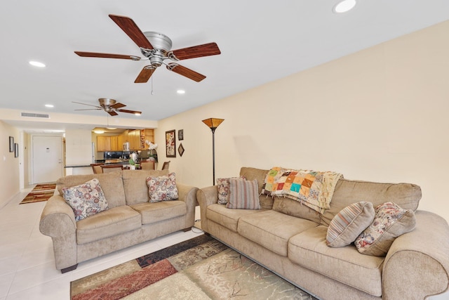 living area with light tile patterned floors, visible vents, and recessed lighting