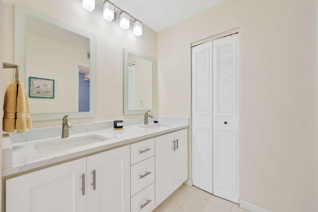 full bath featuring a closet, a sink, and tile patterned floors