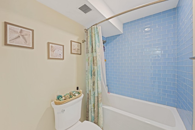 bathroom featuring toilet, shower / bath combination with curtain, and visible vents