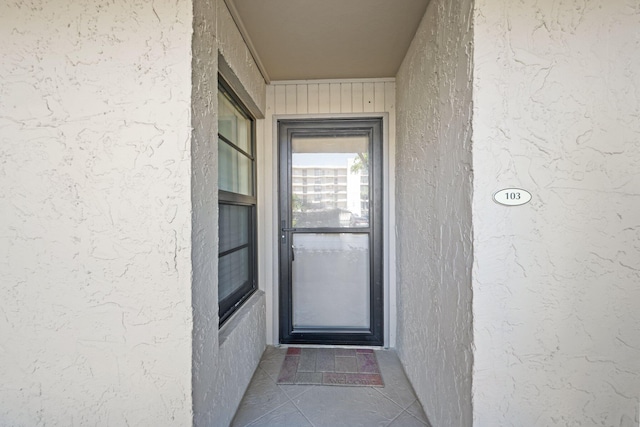 property entrance with stucco siding