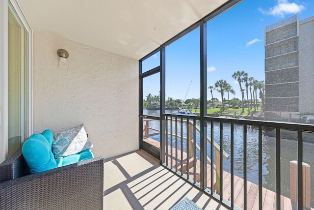 sunroom / solarium with a water view