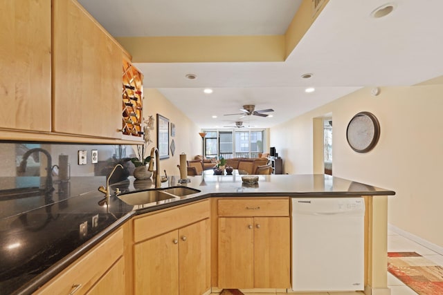 kitchen with white dishwasher, light brown cabinets, recessed lighting, a peninsula, and a sink