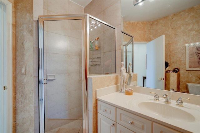 full bath featuring vanity, toilet, and a stall shower