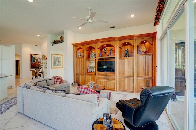 living room with light tile patterned floors, a ceiling fan, and recessed lighting