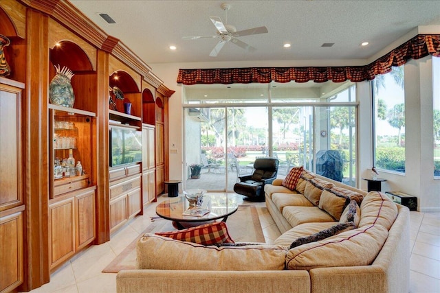 living room with visible vents, a textured ceiling, recessed lighting, light tile patterned flooring, and ceiling fan