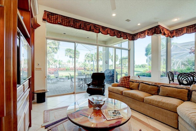 living area with visible vents, recessed lighting, light tile patterned flooring, a textured ceiling, and a ceiling fan