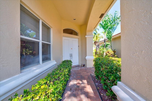 doorway to property with stucco siding