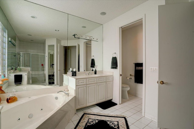 full bathroom featuring toilet, a jetted tub, a shower stall, tile patterned flooring, and vanity