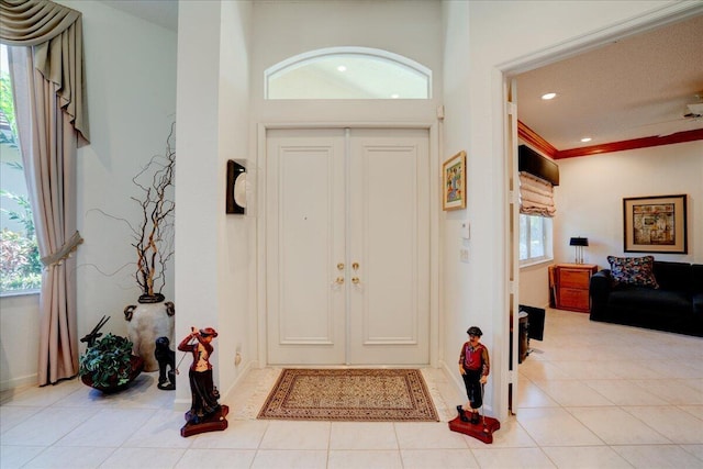 entryway with light tile patterned floors and recessed lighting