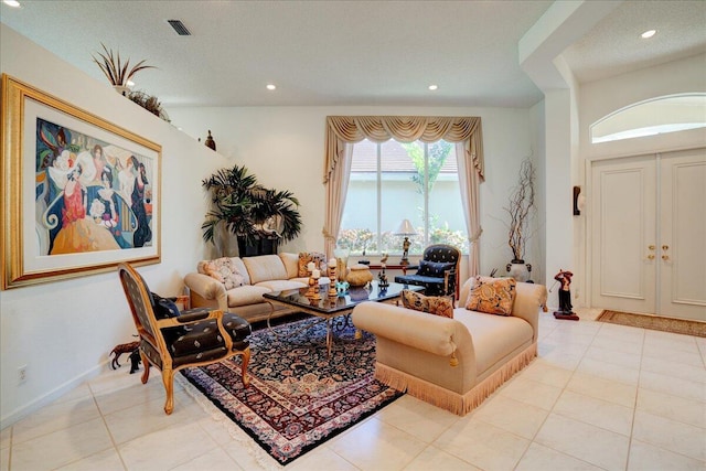 living room with recessed lighting, visible vents, baseboards, and light tile patterned flooring