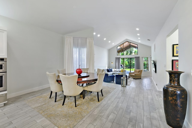 dining space featuring vaulted ceiling, wood finish floors, baseboards, and recessed lighting