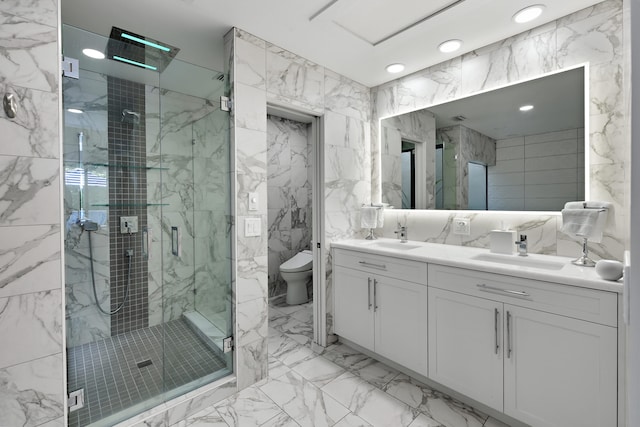 bathroom featuring a sink, a shower stall, toilet, and stone wall