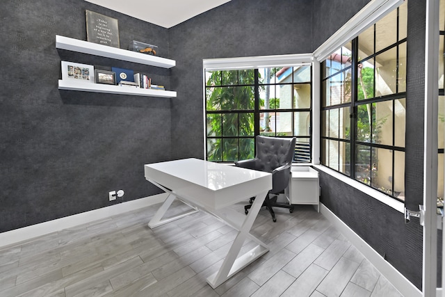 office space with wood tiled floor and baseboards