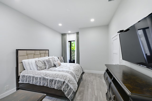 bedroom with light wood-style floors, recessed lighting, and baseboards