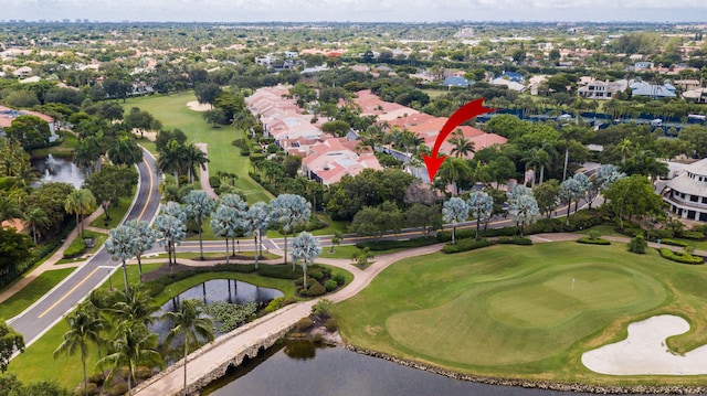 drone / aerial view featuring view of golf course and a water view