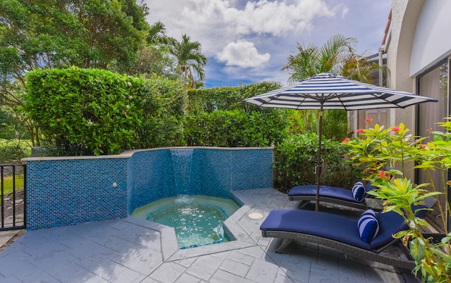 view of pool with a jacuzzi and a patio