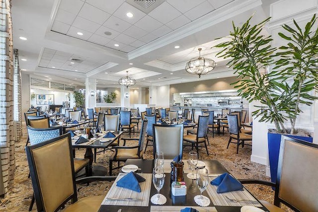 dining area featuring a notable chandelier, visible vents, crown molding, and recessed lighting