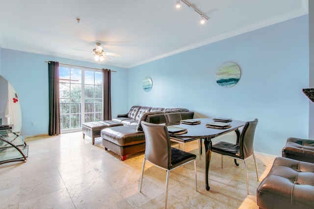 living area with baseboards, rail lighting, a ceiling fan, and crown molding