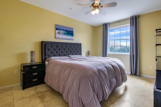 bedroom featuring ceiling fan and baseboards