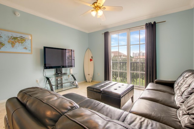 living room with baseboards, ornamental molding, and a ceiling fan