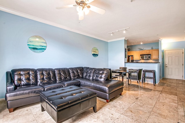 living room with ceiling fan, ornamental molding, and baseboards