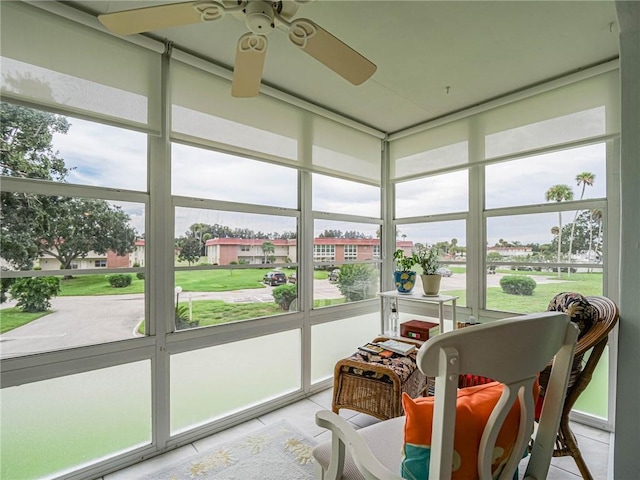 sunroom / solarium with a ceiling fan