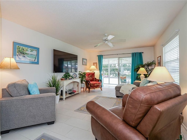 living room featuring a ceiling fan, a healthy amount of sunlight, and a textured ceiling