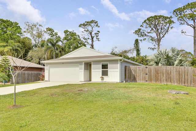 view of front facade featuring a garage, fence, a front lawn, and concrete driveway