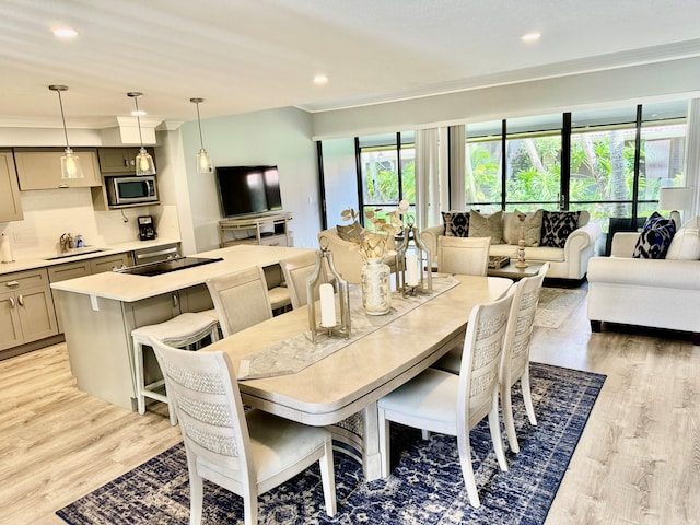 dining space with light wood-type flooring and recessed lighting