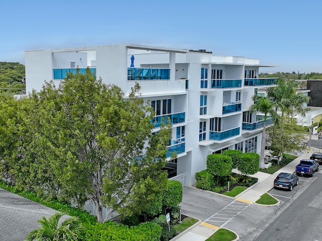 view of building exterior featuring uncovered parking