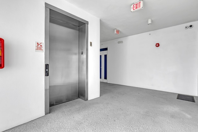 unfurnished room featuring elevator