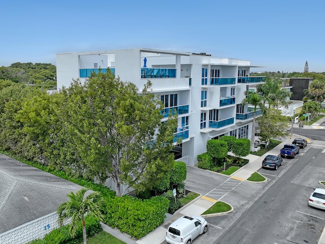 view of building exterior featuring uncovered parking