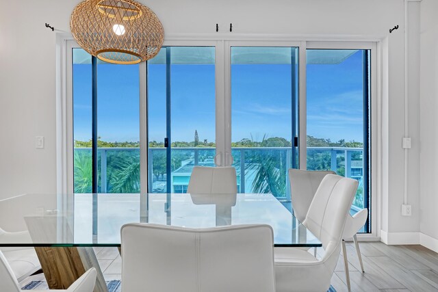 dining room with baseboards, a chandelier, and wood finished floors