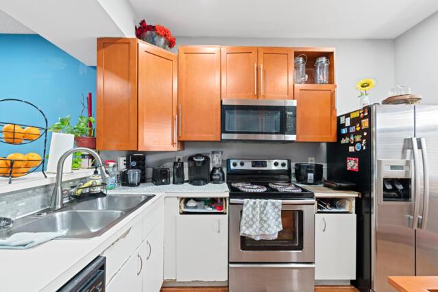 kitchen with light countertops, appliances with stainless steel finishes, and a sink