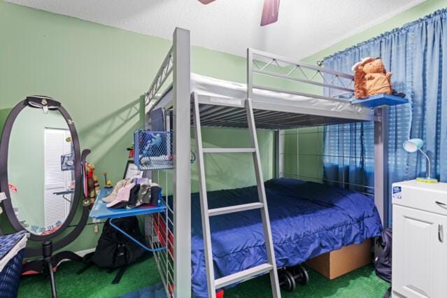 bedroom with ceiling fan and carpet floors