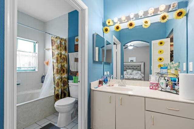 full bathroom with tile patterned flooring, toilet, vanity, a ceiling fan, and ensuite bath