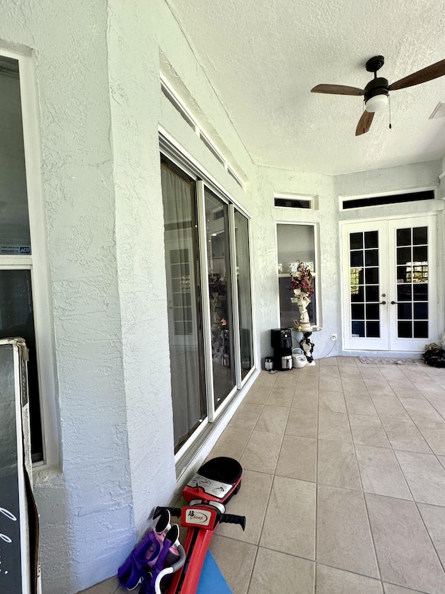 unfurnished sunroom with french doors and ceiling fan