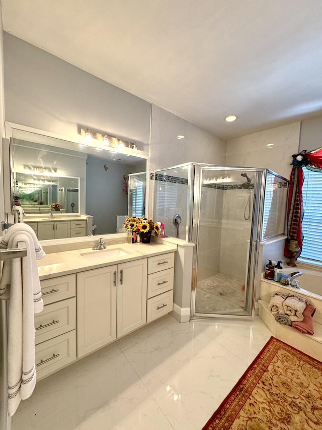 full bath featuring a stall shower, marble finish floor, and vanity