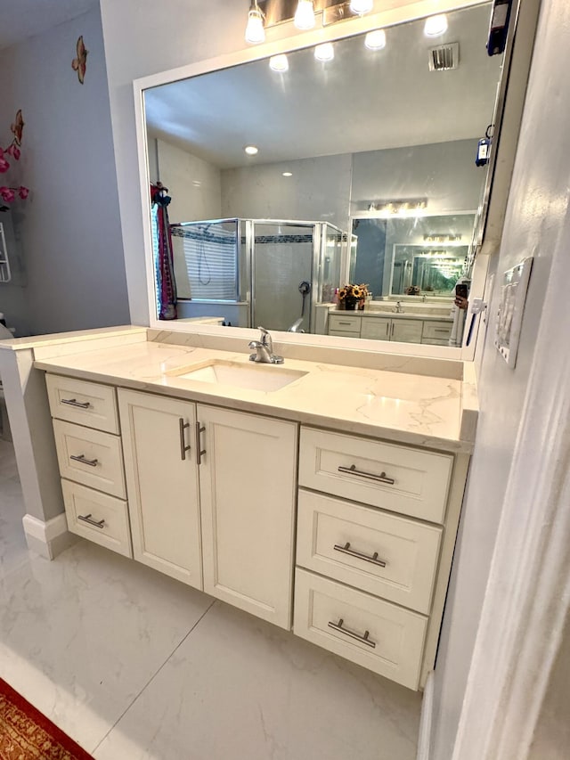 full bath with marble finish floor, visible vents, a shower stall, and vanity